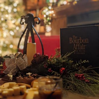 The Bourbon Affair - a glass of bourbon and a plate of cheese and crackers - Cocktail Bars Near Me - Findlay, Ohio