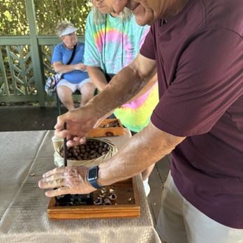 OK Farms - Cracking macadamia nuts - Attraction Farms Near Me - Hilo, Hawaii