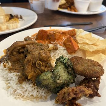 Godavari Austin - a plate of food on a table - Indian Near Me - Austin, Texas Godavari Austin - a plate of food on a table - Indian Near Me - Austin, Texas