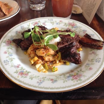Milktooth - From the "Of the Moment" portion of the menu: Grilled hanger steak with stir fried cabbage ($20). Half a slice of sorghum glazed bacon ($5). - Breakfast & Brunch Near Me - Indianapolis, Indiana