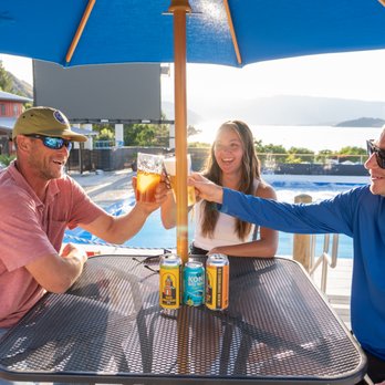 Twocan Jenny's - a group of people toasting at a table - Beer Bar Near Me - Chelan, Washington Twocan Jenny's - a group of people toasting at a table - Beer Bar Near Me - Chelan, Washington