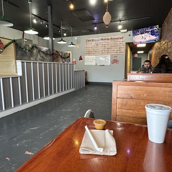 Casa Grande - a table with a cup of coffee and a donut on it - Mexican Near Me - Lawrence, Kansas
