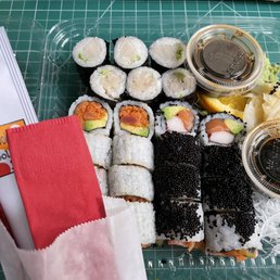 Negi Hamachi, Spicy Tuna, Alaskan Maki rolls, and elegant cutlery. Negi Hamachi, Spicy Tuna, Alaskan Maki rolls, and elegant cutlery.