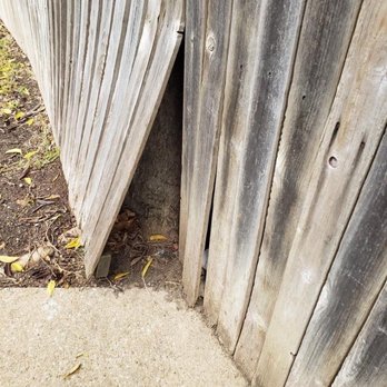 Lobos Concrete - a wooden fence with a hole in it - Masonry/Concrete Near Me