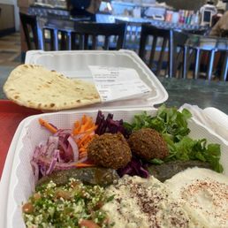 App. Combo plate (15.99) pita bread top. Then Turkish salad, falafels, dolmas. Bottom left to right: baba ghanoush, tzatziki, hummus. App. Combo plate (15.99) pita bread top. Then Turkish salad, falafels, dolmas. Bottom left to right: baba ghanoush, tzatziki, hummus.