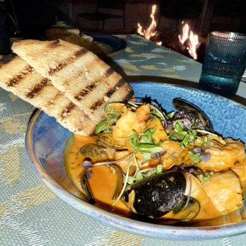 Covewood - Cioppino $46 with mussels, scallops, clams, snapper, shrimp, saffron-tomato emulsion, rouille (a spicy French-style elevated mayonnaise), an - New American Near Me - San Diego, California
