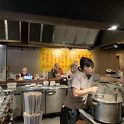 Photo of 原宿餃子樓 - Shibuya, 東京都, Japan. Seating around central kitchen