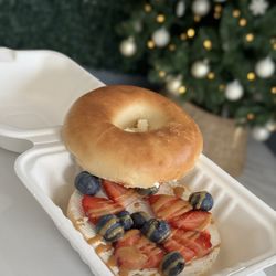 The Urban Press - Bagel with cream cheese topped with berries and peanut butter