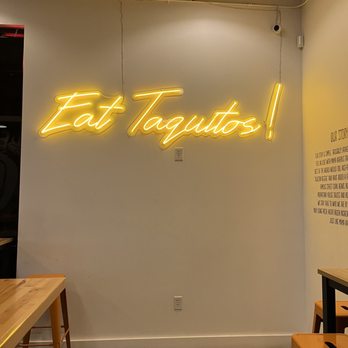Roll Em Up Taquitos - Colton - Wall neon slogan - Mexican Near Me - Colton, California