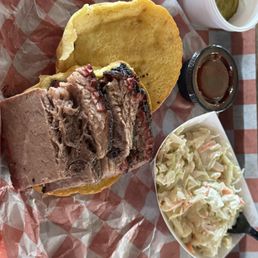Custom brisket sandwich, comes with your choice of herbed potato salad or Cole slaw. Custom brisket sandwich, comes with your choice of herbed potato salad or Cole slaw.