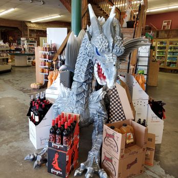 Thorp Fruit & Antique Mall - a dragon statue surrounded by boxes and bottles - Antiques Near Me - Thorp, Washington Thorp Fruit & Antique Mall - a dragon statue surrounded by boxes and bottles - Antiques Near Me - Thorp, Washington