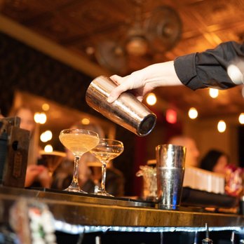 Vault - a bartender pouring a drink at a bar - Venues & Event Spaces Near Me - Cleveland, Ohio Vault - a bartender pouring a drink at a bar - Venues & Event Spaces Near Me - Cleveland, Ohio