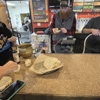 White Flame Brewing Co - Head brewer, and beer tender tasting some spent grain homemade sourdough bread, brought in by one of there best customers - Breweries Near Me - Hudsonville, Michigan White Flame Brewing Co - Head brewer, and beer tender tasting some spent grain homemade sourdough bread, brought in by one of there best customers - Breweries Near Me - Hudsonville, Michigan