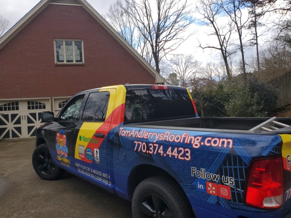 Slide of Tom and Jerry's Roofing