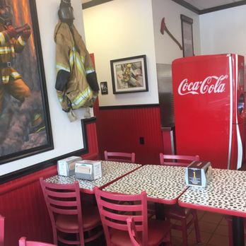 Firehouse Subs - a table and chairs in a restaurant - Fast Food Near Me - Richmond, Virginia