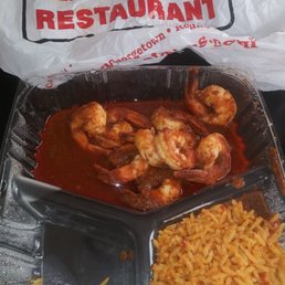 a plastic container filled with rice and shrimp