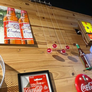 Red's Grill - a wooden table with a bowl of soup and a bottle of coke - American Near Me - Richmond, Texas