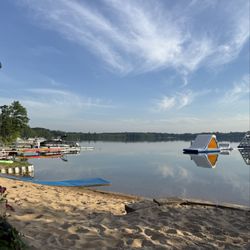Cabin Fever Round Lake Resort - Private beach, floating inflatable slides and climbing tower.