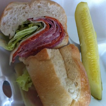 River Safari Cafe - a sandwich and pickle in a styrofoam container - Delis Near Me - Homosassa, Florida River Safari Cafe - a sandwich and pickle in a styrofoam container - Delis Near Me - Homosassa, Florida