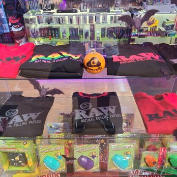 Cloud 9 - RAW Shirts $29.99 and RAW Sweaters $39.99 - A glass display case showcases RAW branded T-shirts, sweatshirts, and a hat, along with Smokebuddy air filters in a retail store setting. - Head Shops Near Me - Ukiah, California