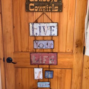 The Moose Outpost - a wooden door with a sign that says cowboys cowgirls - Burgers Near Me - Dubois, Wyoming