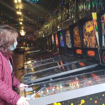 Free Gold Watch - Sharon Bowman playing pinball in SF. - Printing Services Near Me - San Francisco, California