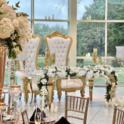 Le Chateau de Crystale Events - Gorgeous head table decor with floral table garland king and queen thrones gold vases and chandeliers at newton white mansion.
