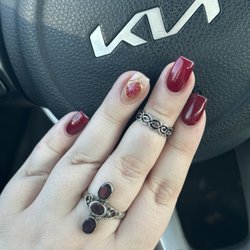 Kiss Nails - A hand showing a nail design