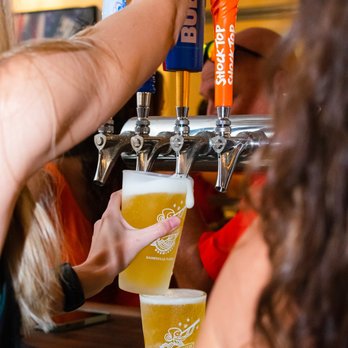 The Swamp Restaurant - The Swamp restaurant bartenders pouring some draft beer at the bar. - Venues & Event Spaces Near Me - Gainesville, Florida The Swamp Restaurant - The Swamp restaurant bartenders pouring some draft beer at the bar. - Venues & Event Spaces Near Me - Gainesville, Florida