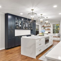 Kitchen Doctors - Award-winning kitchen, Shaker-style white cabinets, navy blue reduced depth tall pantries, quartz countertops