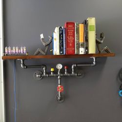 Katonah Shipping & Business Center - Steampunk shelf, nixie tube clock, bookends made of railroad spikes and some books for ambience.