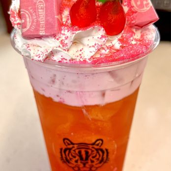 Neon Tiger Coffee - a cup of iced tea with a strawberry and gummy bear on top - Coffee & Tea Near Me - Odessa, Texas Neon Tiger Coffee - a cup of iced tea with a strawberry and gummy bear on top - Coffee & Tea Near Me - Odessa, Texas