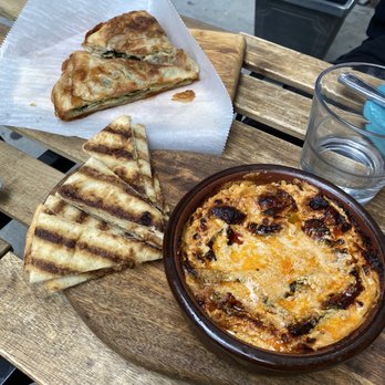 Dua Kafe - Ferguese to the right came with pita bread and spinach byrek on the left on parchment - Cafes Near Me - New York, New York Dua Kafe - Ferguese to the right came with pita bread and spinach byrek on the left on parchment - Cafes Near Me - New York, New York