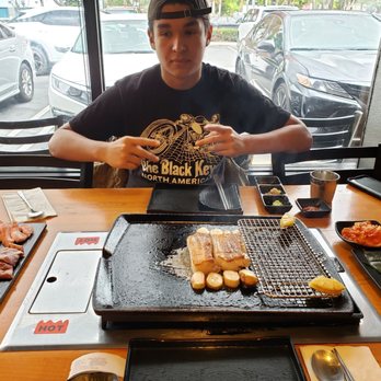 Sookdal - Me and my friend trying it out, Kevin, our server, did a fantastic job both keeping us engaged and cooking while showing us the ropes. - Korean Near Me - Garden Grove, California