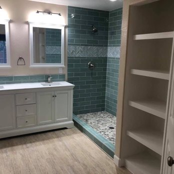 Shiny Star Construction - Before the renovation there was a grody phone booth style shower where he built the linen shelving. - General Contractors Near Me