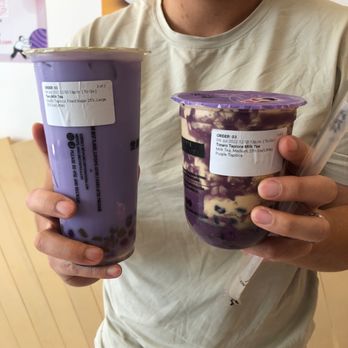 OneZo - a man holding two cups of yogurt - Bubble Tea Near Me - Ottawa, Ontario