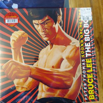Dusty Groove - happiLee found this gem 3 - The album cover shows Bruce Lee shirtless, with a serious expression, flexing his muscles against a background of red and black rays. - Music & DVDs Near Me - Chicago, Illinois