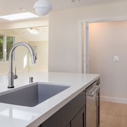 Top Remodeling & Design - Perfect for entertaining! Top Remodeling & Design created this beautiful kitchen with custom cabinetry and elegant lighting.