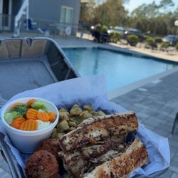 Patti’s Seafood - Mahi mahi dinner plate. Tons of dried okra and the hush puppies have bits of corn in it! by the hotel pool