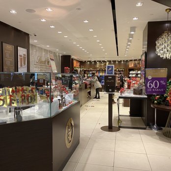 Lindt - the inside of a store with many items on display - Chocolatiers & Shops Near Me - Montreal, Quebec