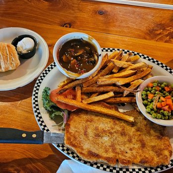 Westside Lilo's Cafe - Schweine Jäger Schnitzel, side of dark mushroom gravy, fries, overcooked peas & carrots, roll & butter - Breakfast & Brunch Near Me - Seligman, Arizona