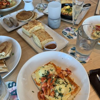 Canvas - Cuban sandwich (left), lobster Benedict (middle), bacon skillet (top) and sides of biscuits and pancake - New American Near Me - Orlando, Florida