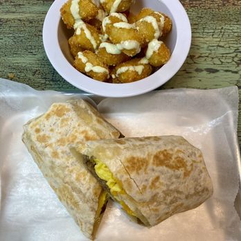 Danny's Coffee & Friends - American American Breakfast Burrito and tatie tots with a garlic cilantro aioli sauce - Latin American Near Me - Tampa, Florida Danny's Coffee & Friends - American American Breakfast Burrito and tatie tots with a garlic cilantro aioli sauce - Latin American Near Me - Tampa, Florida