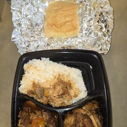 Brown stew chicken with rice and coco bread Brown stew chicken with rice and coco bread