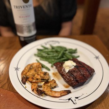 Saltgrass Steak House - Filet, grilled shrimp and seared green beans.  Notice the Malbec in the back pairing the meal perfectly. - Steakhouses Near Me - Bee Cave, Texas