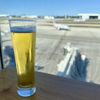 The Centurion Lounge - Beer and view of northern runway - Airport Lounges Near Me - Miami, Florida The Centurion Lounge - Beer and view of northern runway - Airport Lounges Near Me - Miami, Florida