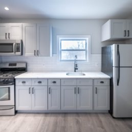 Terraform Construction - a kitchen with white cabinets and stainless steel appliances - General Contractors Near Me - Brooklyn, New York