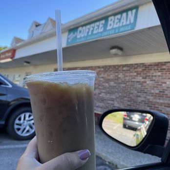 Little Coffee Bean - a hand holding a cup of iced coffee - Coffee & Tea Near Me - Upton, Massachusetts