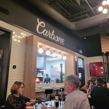 Casa Carbone - a group of people sitting at a table - Italian Near Me - Aurora, Ontario
