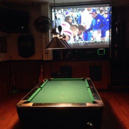 a pool table in front of a tv